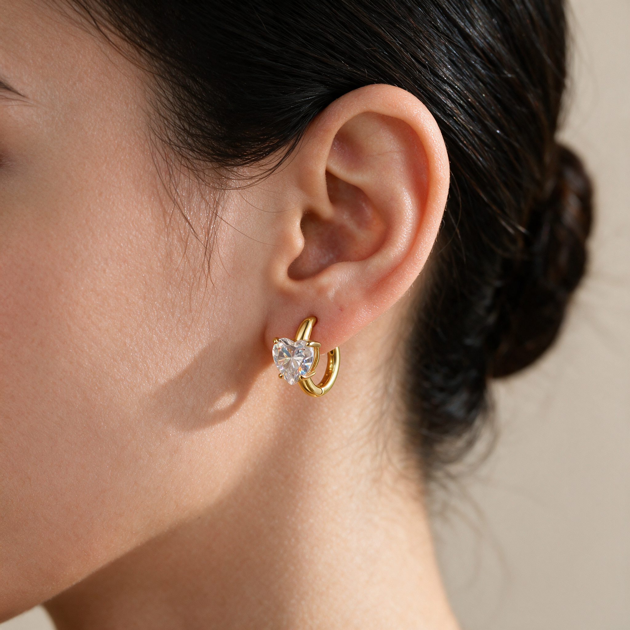 Lunette Heart Huggie Earring worn on ear in 14k Gold